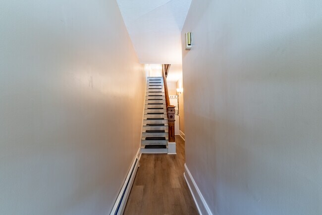 Entrance hallway from front door up stairs into the main floor of the apartment. - 506 Washington St