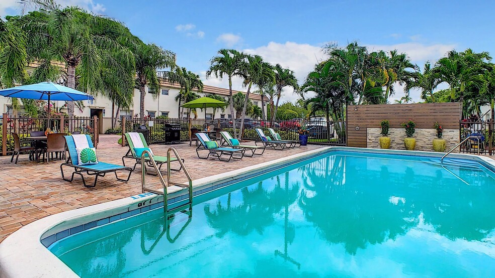 Our pool area's vibrant energy and expansive sun deck create a perfect haven for fun in the sun at Boca Winds. - Boca Winds