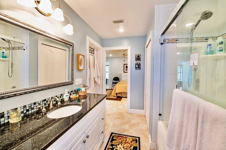 2nd en-suite bath with jetted tub/shower combo and view into bedroom - 6710 S Highway A1A