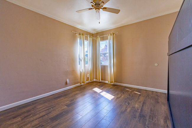 Bedroom 2 - Largest room comes w/ceiling fan & full sized wall bed - 6401 Arlington Ave