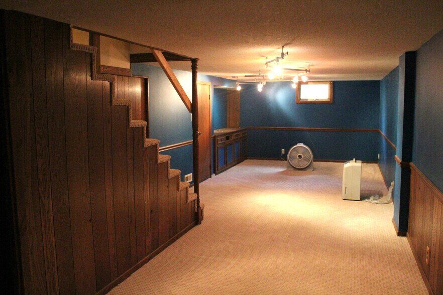 The basement has a large family room with built-in entertainment center space. - 1624 elmhurst ave