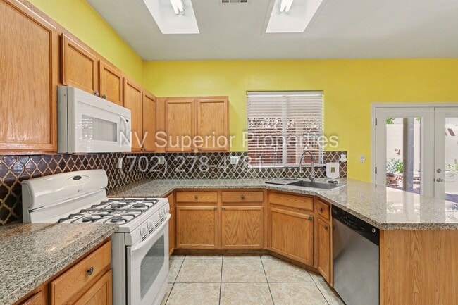 Building Photo - NW!! 4 Bedrooms!!! All Tile and Pergo flooring T/O!! NO Carpet!!! Low Maintenance Desert landscap...