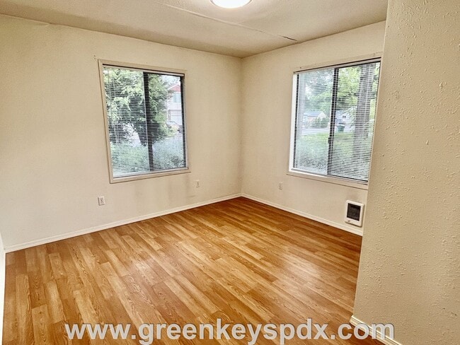 Building Photo - This 3-bedroom 1-bathroom house has a large front yard and a mostly fenced backyard.