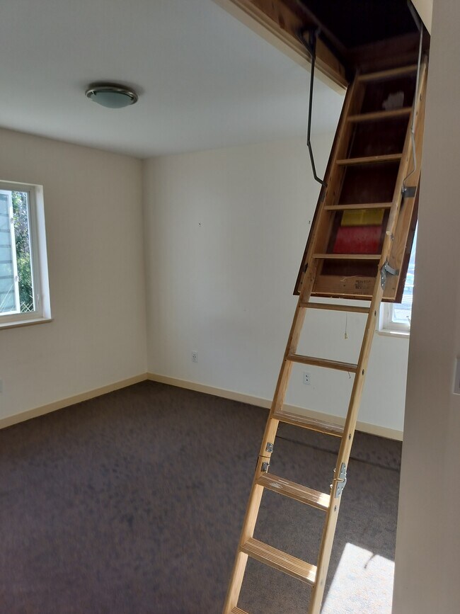 Main bedroom with attic storage - 16261 SE Sun Ave
