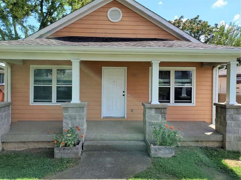 Covered front porch with garden beds for a small flower or herb garden. - 1025 Wade Ave