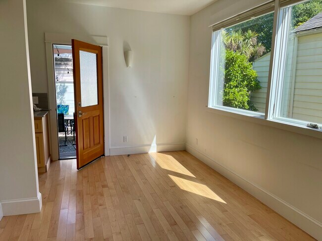 Living room features big windows and door to patio - 3918 Webster St