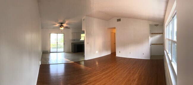 View from corner of the living room with dining room and entrance to the hallway viewable - 85 Wilson Ave