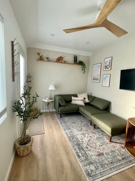 Cozy living room space. TV is smart and comes out from the wall. High ceilings throughout! - 4661 Berwick Dr
