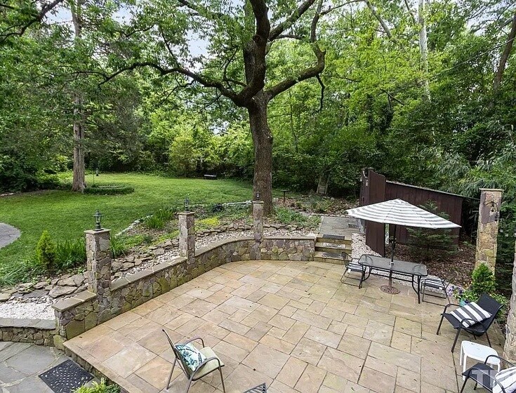 Adjacent yard and limestone patio (shared) - 115 W Woodridge Dr