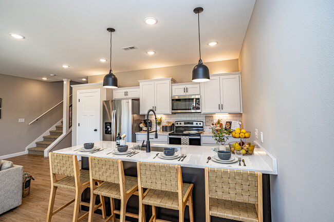 Ample cabinet space, a breakfast bar with pendant lighting and a closet pantry - 110 Sierra Cir