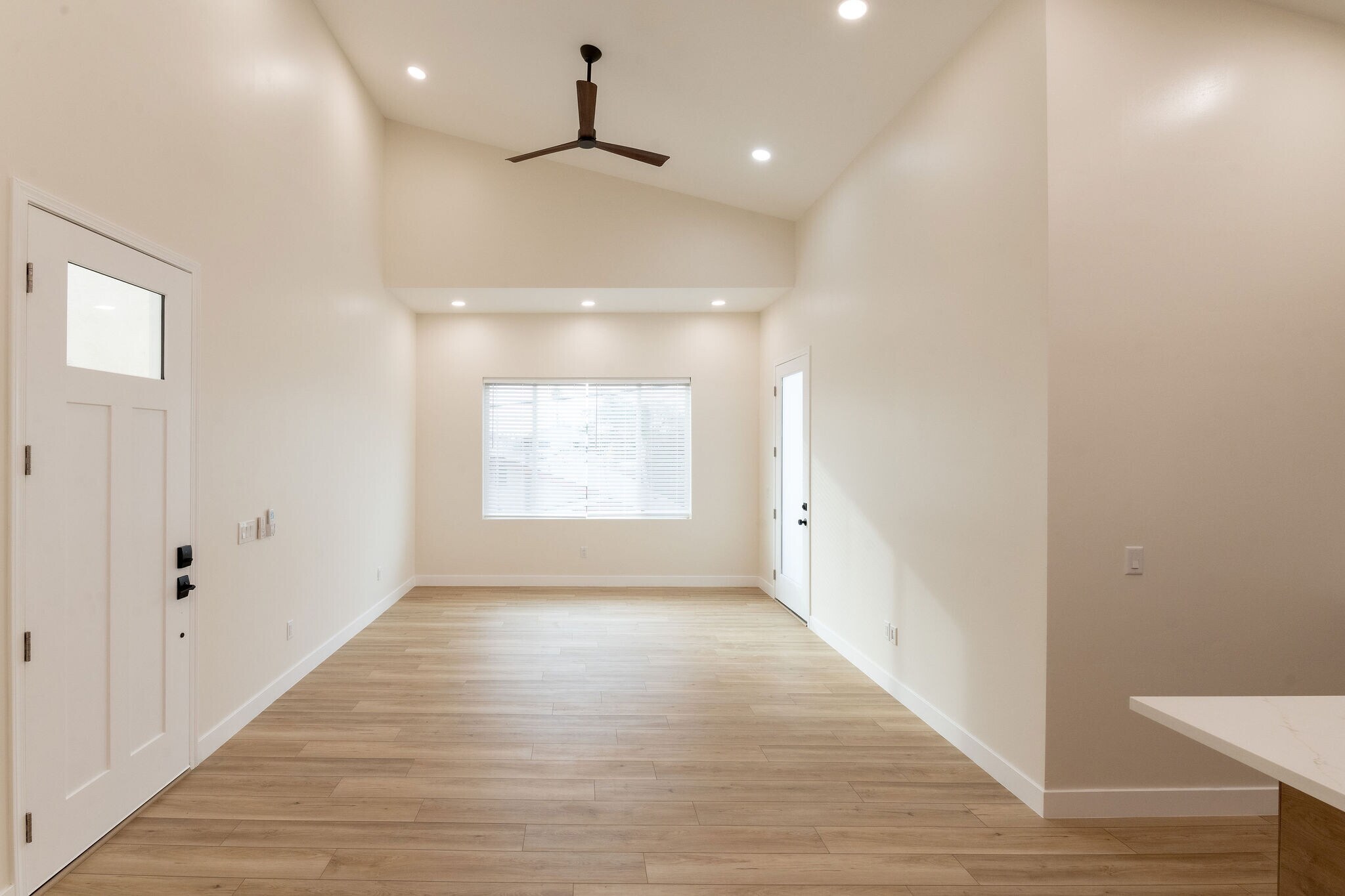 View of living space. Front door to the left. Door on right is to roof top deck - 4774 Bancroft St