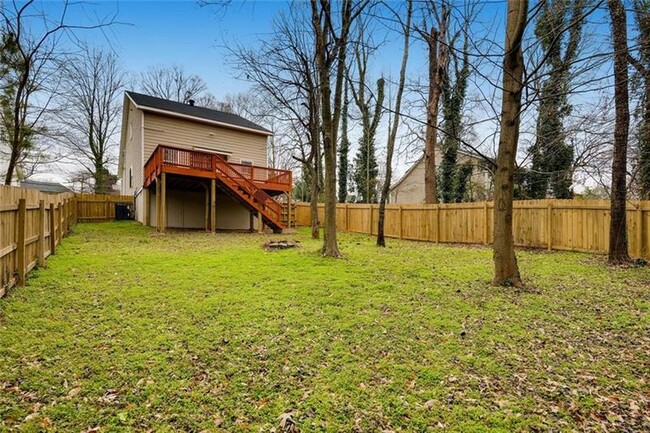 Backyard with a deck and gated fence. - 1999 Meador Ave SE