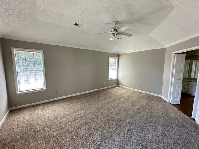 Building Photo - Grand 4BR/2BA Near Southwind | 2,438 Sq Ft, Stone Fireplace, Soaking Tub & 2-Car Garage