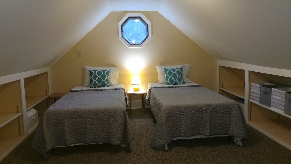 What it looks like when loft is set w/ 2 Twin XL beds (walls /shelves have been painted white since) - 156 Henry St