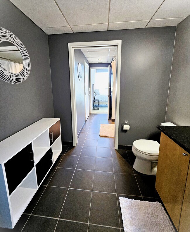 The ceramic tiled bath also has a convenient in-unit laundry closet - 8161 33rd Ave S