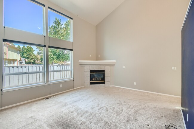 Living room w/ gas fireplace - 1437 NE Birkshire Ct