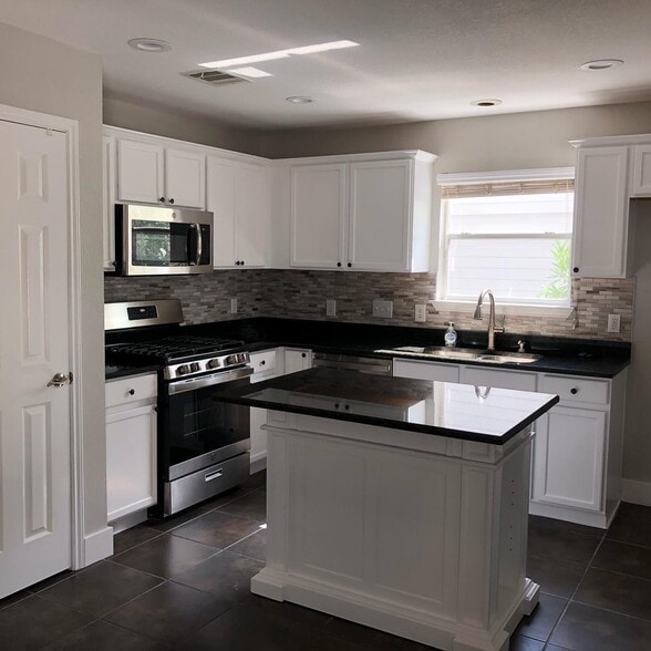 Fully-remodeled kitchen with recessed lighting, stainless steel appliances and granite - 615 Big Spring Dr