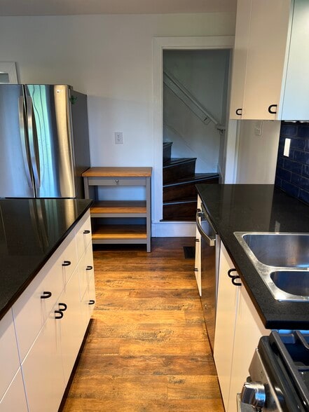 Coffee bar located next to the fridge with additional storage room. - 126 Merion Ave
