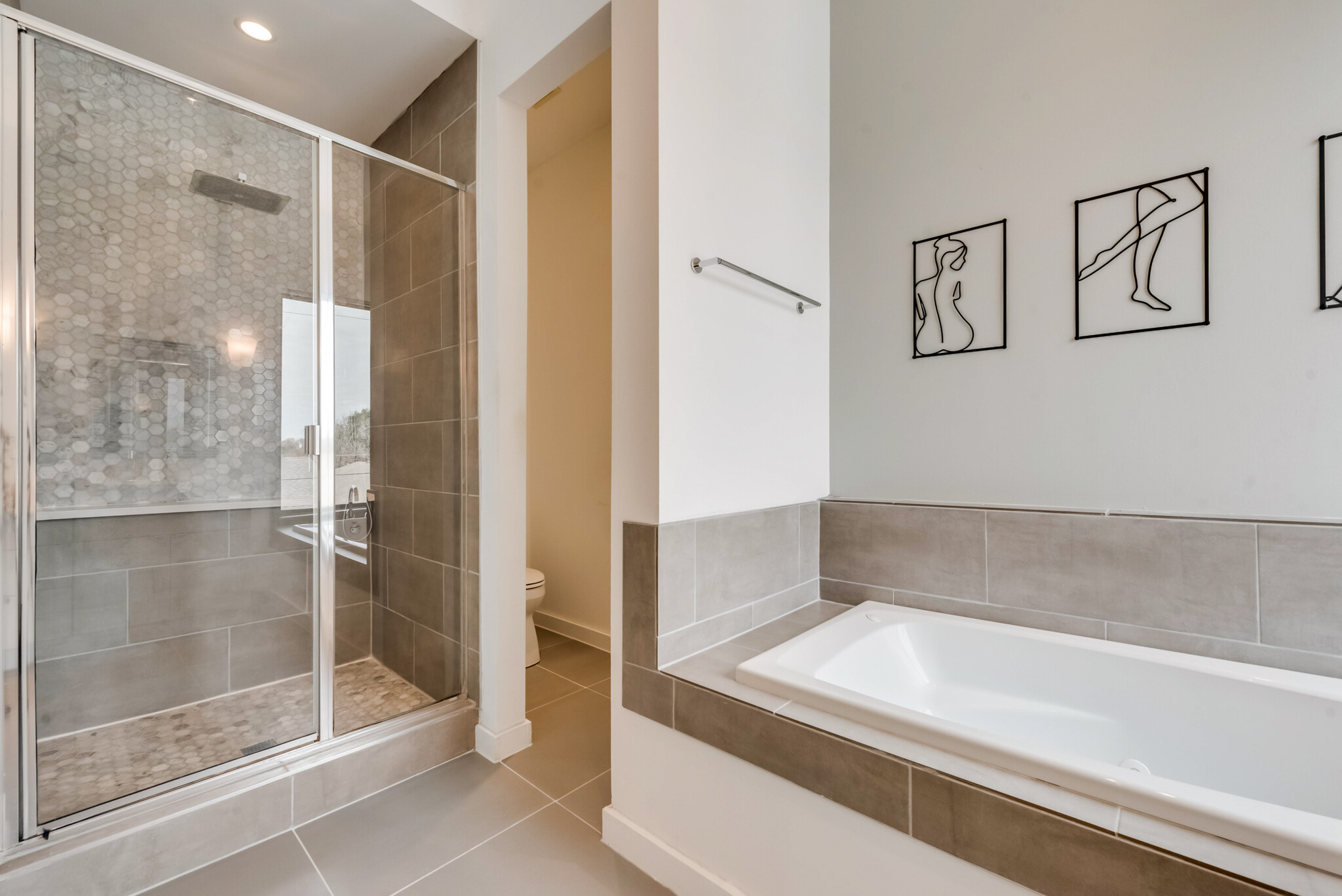 The master bathroom has a soaker tub and a separate walk-in shower. - 4434 Holland Ave