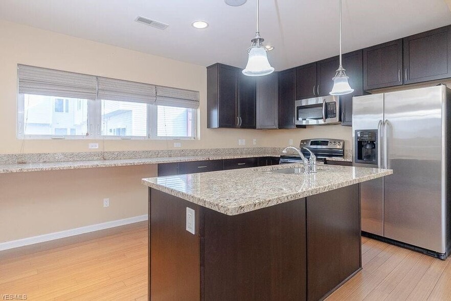 Granite countertops, stainless steel appliances, and room for a wine fridge. - 1263 W 74th St.