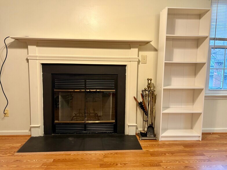 Operable wood-burning fireplace comes with necessary fire tools, additional ‘built-in’ bookshelf - 208 Quarter Trl