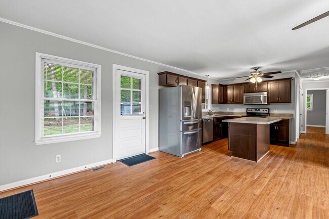 Building Photo - Updated Home, Stainless Steel Appliances, Wood Like Flooring, Deck, Garage!
