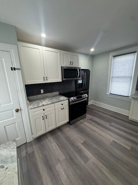 Kitchen- white door is access to the basement where the washer and dryer are - 609 Broad Ave