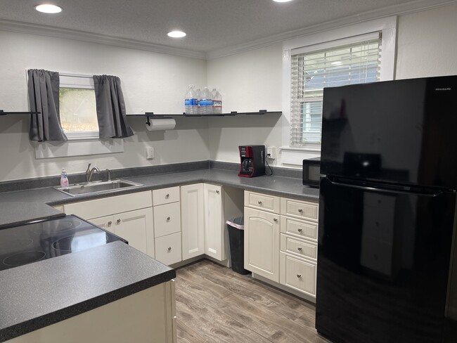 Kitchen with brand new refrigerator - 110 W 6th St