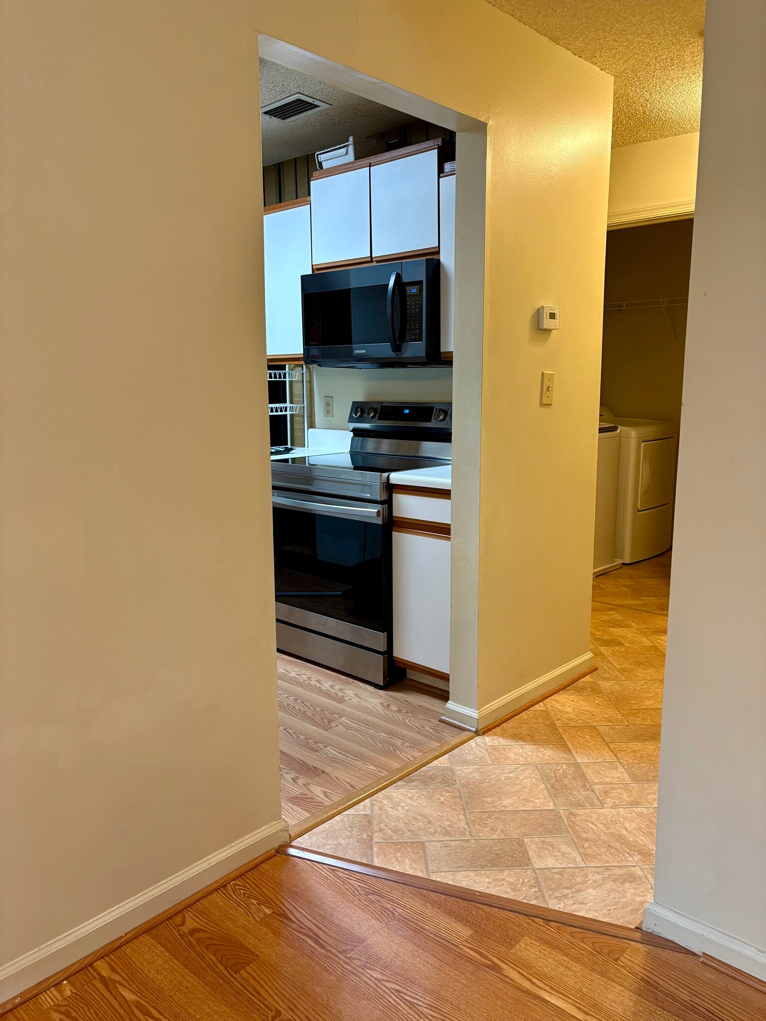 View of hallway and into kitchen from great room - 208 Quarter Trl