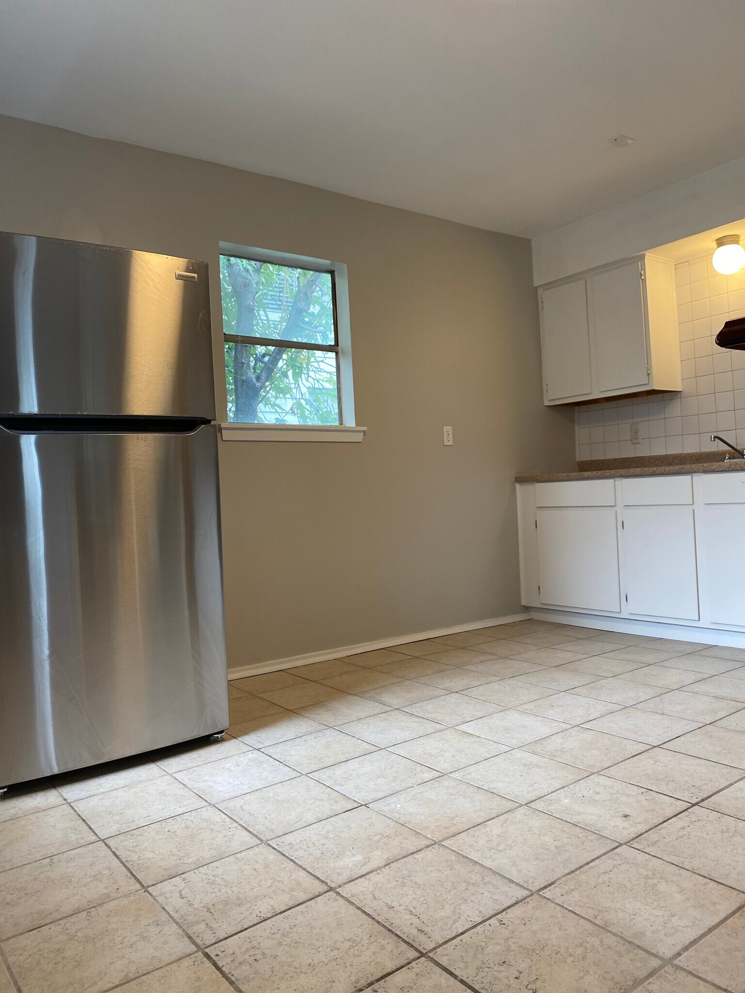 spacious kitchen with room for a small table and chairs - 4422 Bell St