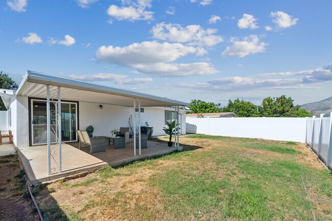 Spacious backyard featuring outdoor furniture, perfect for relaxing and entertaining! - 9853 Saint George St