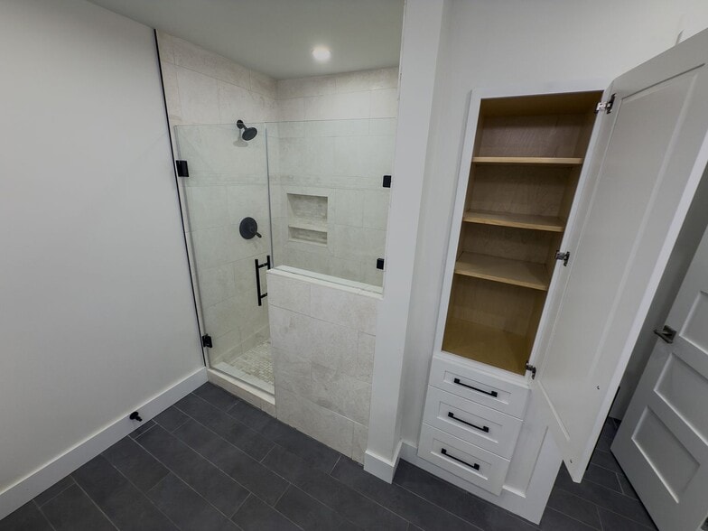 step-in shower with glass enclosure and built-in linen storage - 2006 Candle Ct