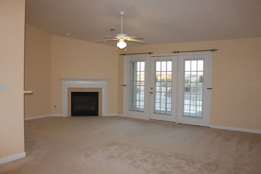Living room with fireplace and cathedral ceiling - 5628 Harbourwatch Way