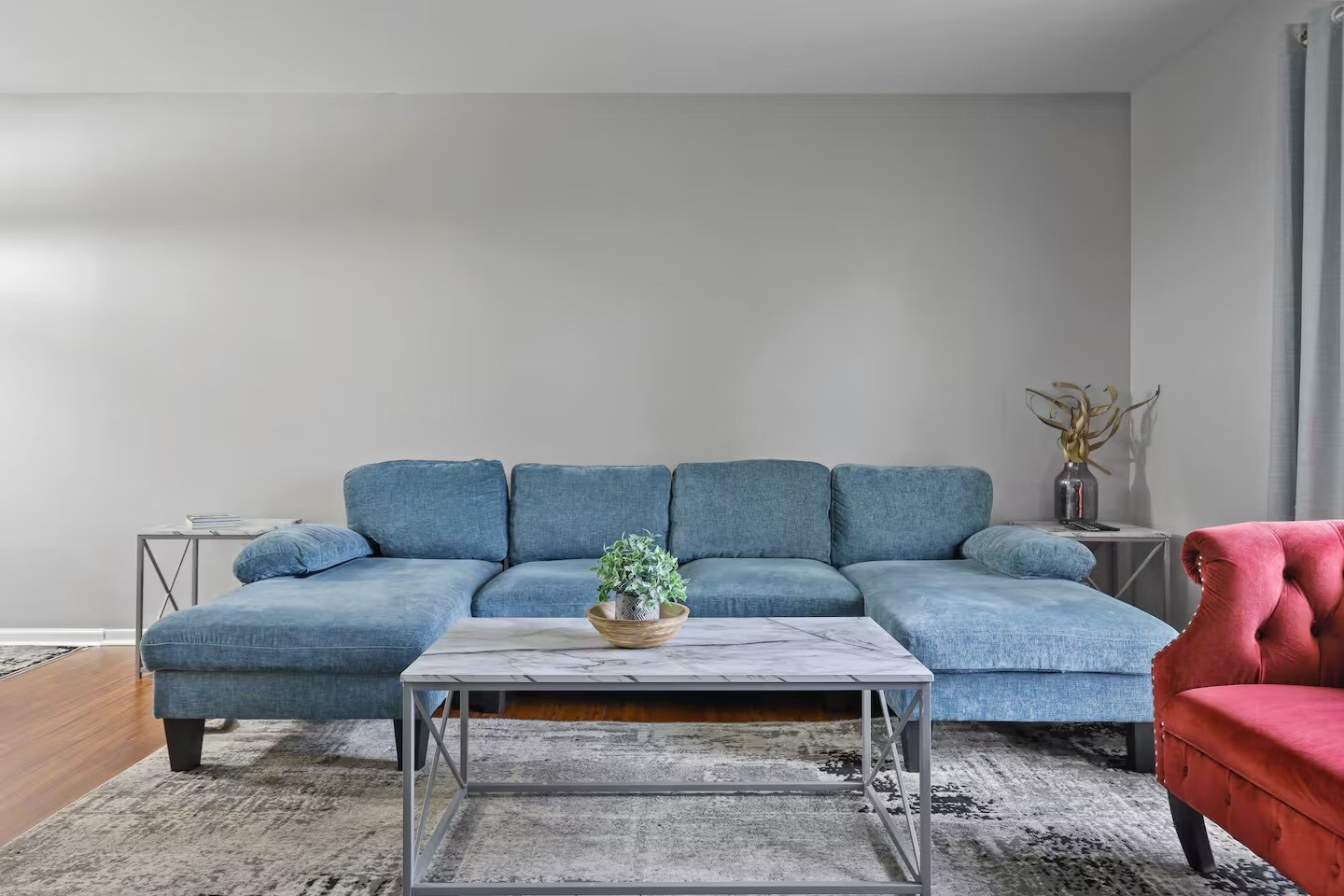 Living room with sleeper couch, smart TV and closet space. - 1002 Juniper Ln