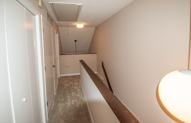 Upstairs Hallway. Laundry closet is on the left followed by the door to the HVAC Unit & Water Heater - 115 Beechnut St