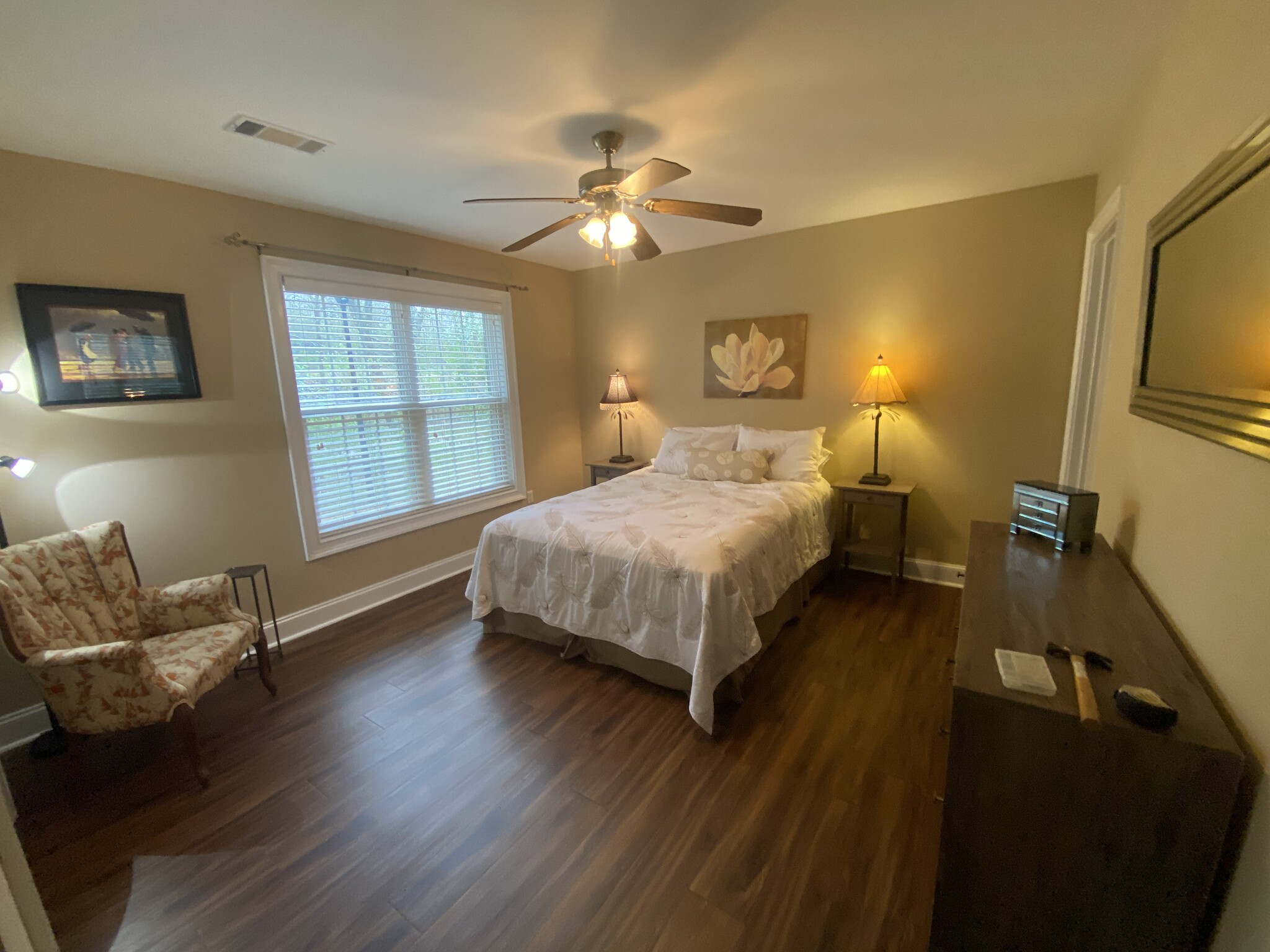 Master bedroom with large closet, six drawer dresser, wall mounted smart tv, and ensuite bathroom. - 600 Mitchell Bridge Rd