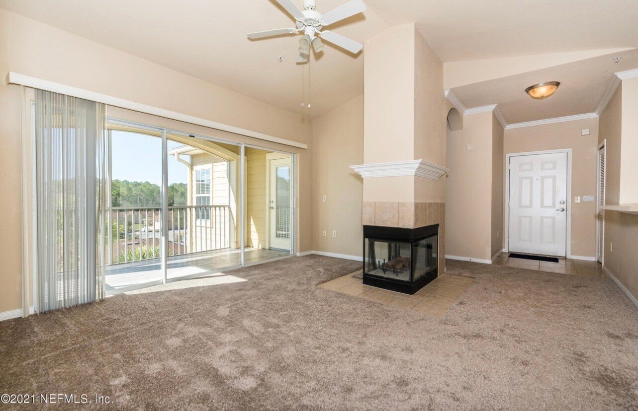 Family room w fireplace and sliding doors to screened terrace - 275 Old Village Center Cir