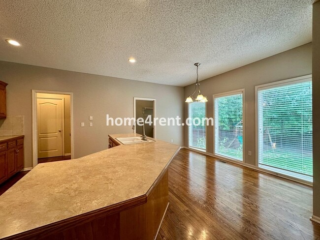 Building Photo - Beautiful Four-Bedroom Home with Three Car Garage, Wood Floors, Finished Basement and a Fenced Ya...