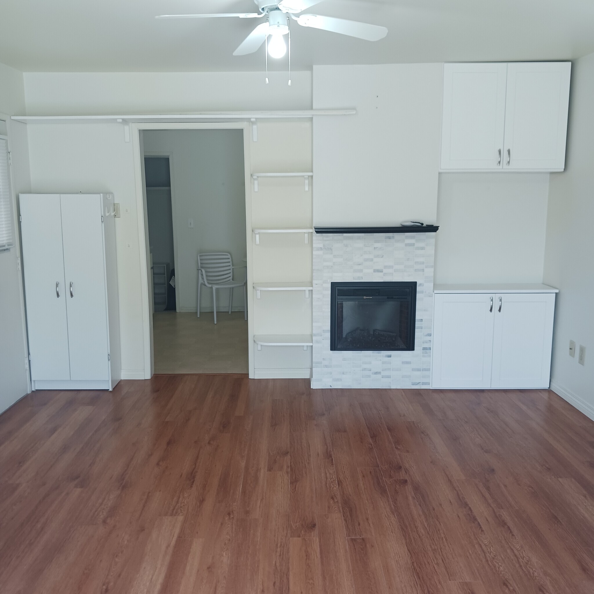 Living room with electric fireplace. - 129 S Irena Ave