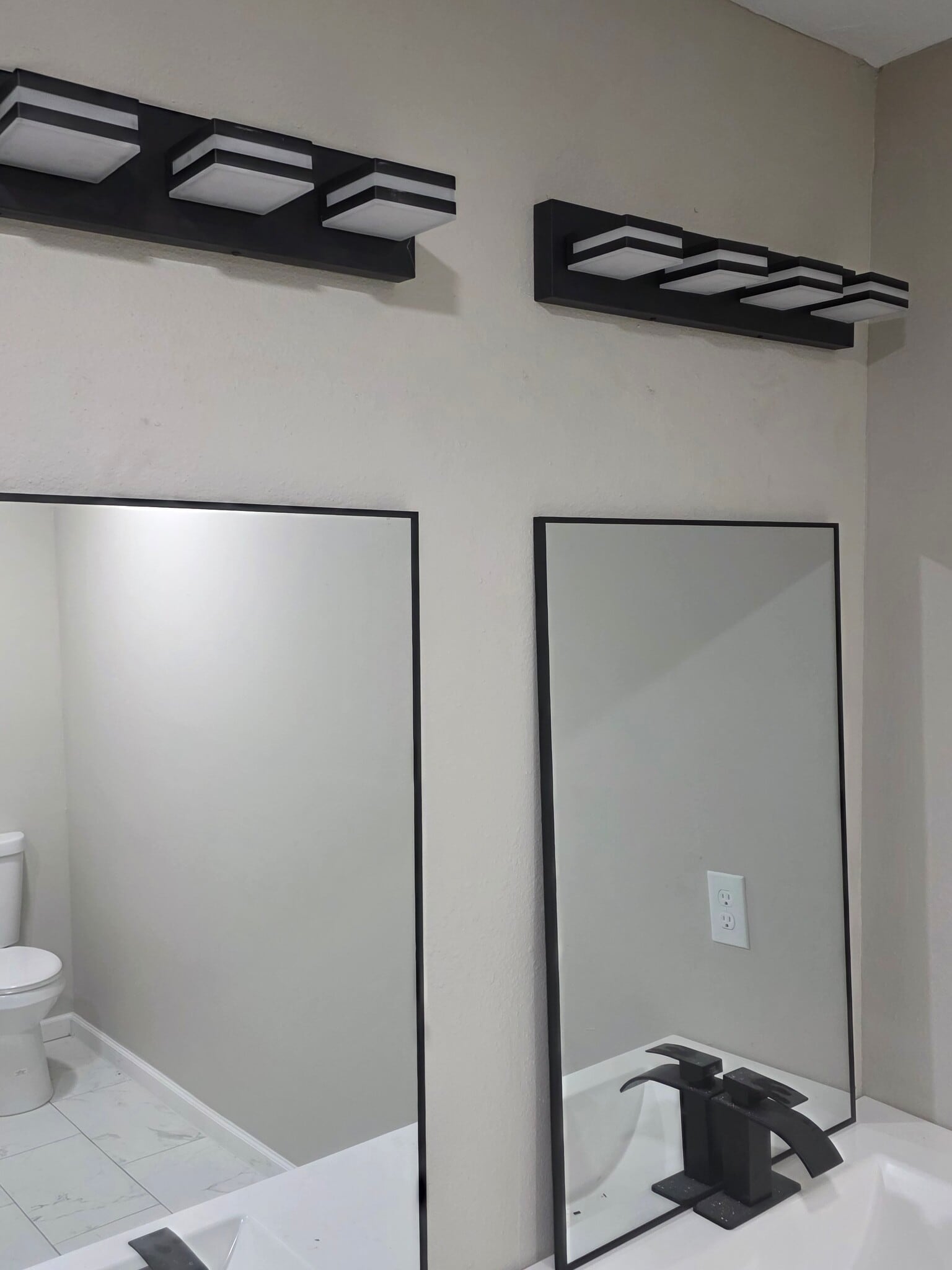 primary bathroom with mirrors and faucets on double sink - 4701 Cherry St