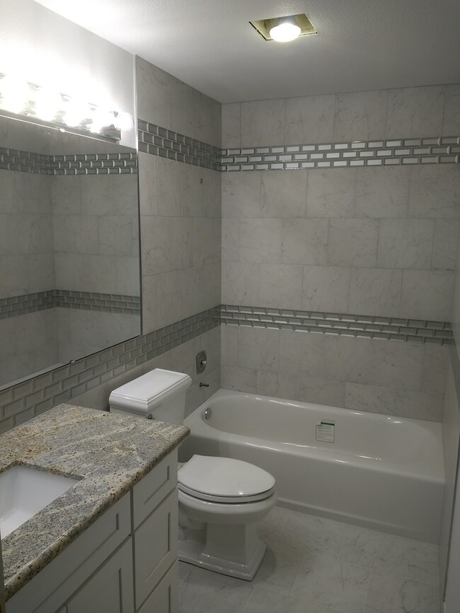 Extensive use of tile in bright and clean bathroom. - 3206 Pine Rd NE