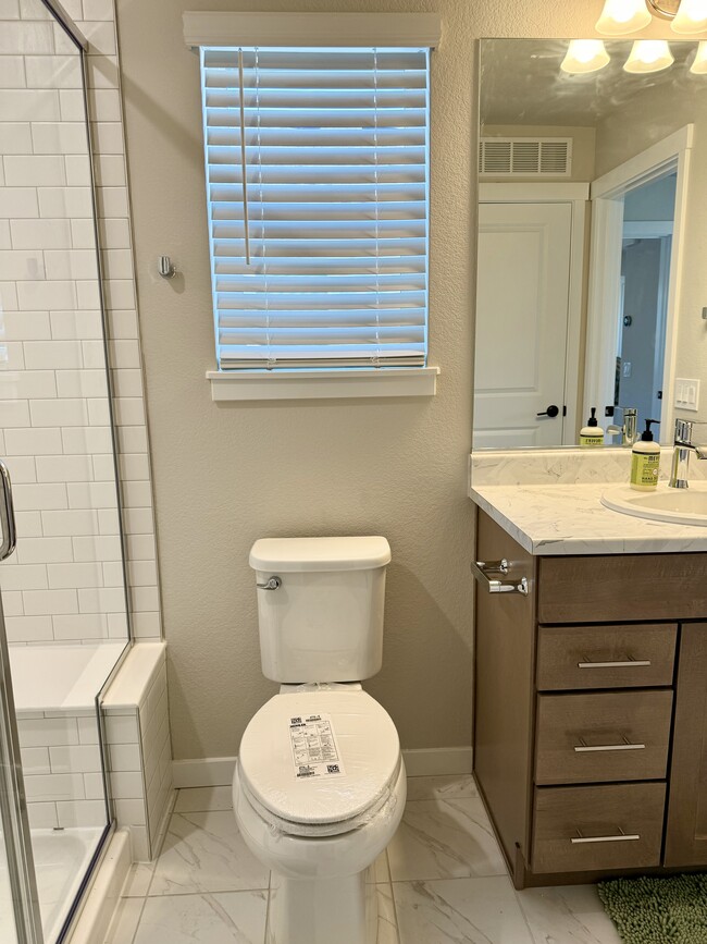 Elegant Bathroom: Features clean lines, modern fixtures, and plenty of storage for your essentials. - 6125 Lantana Light Vw