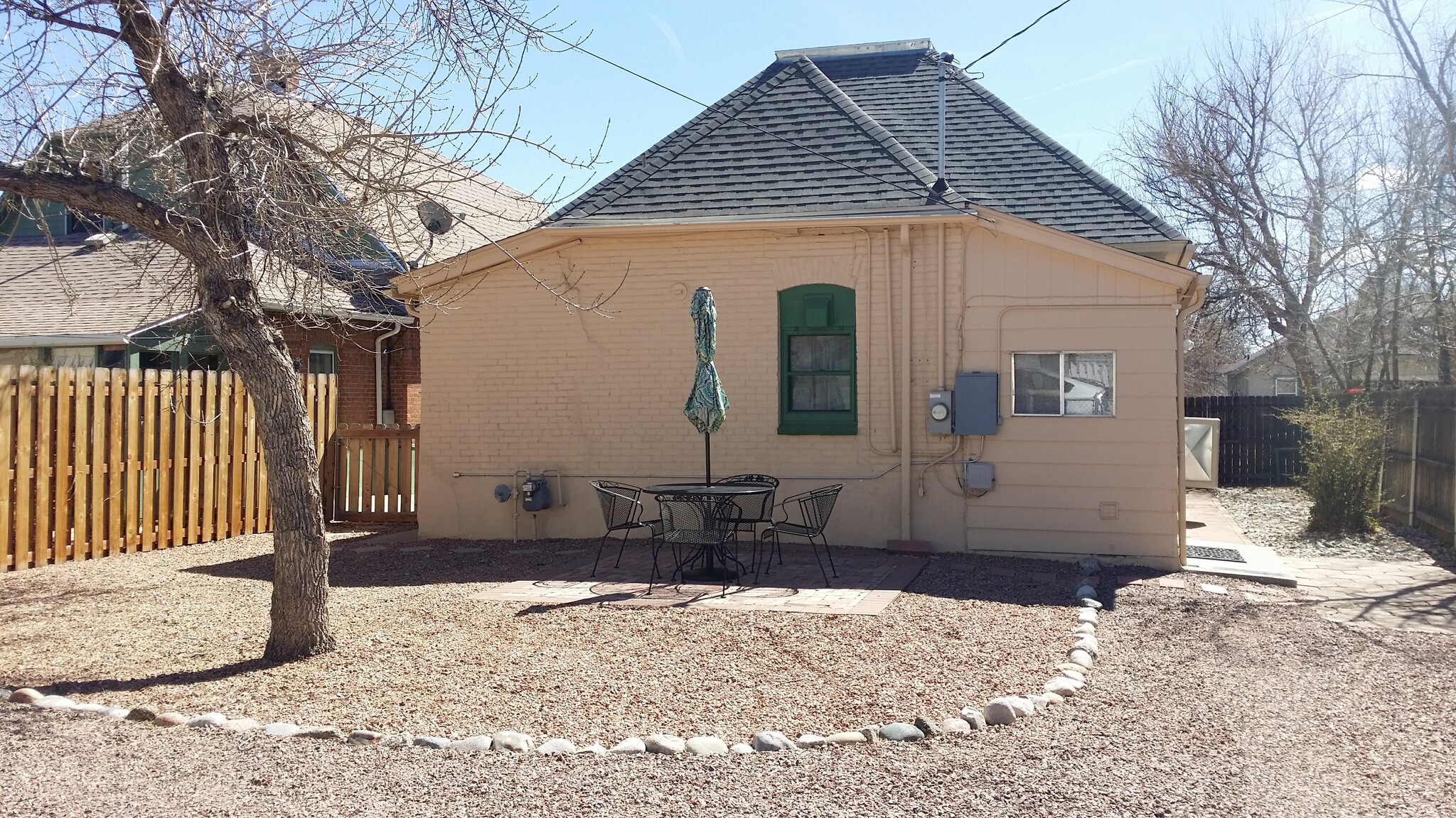 Back yard with designated parking spot (Patio table and umbrella are NOT included with rental) - 607 Harrison Ave