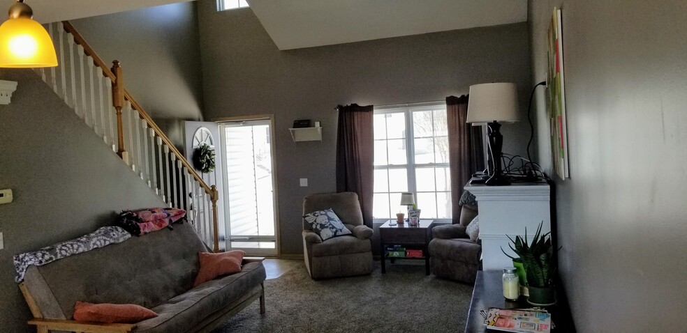 Bright living room with soaring ceilings. - 6965 N 88th St