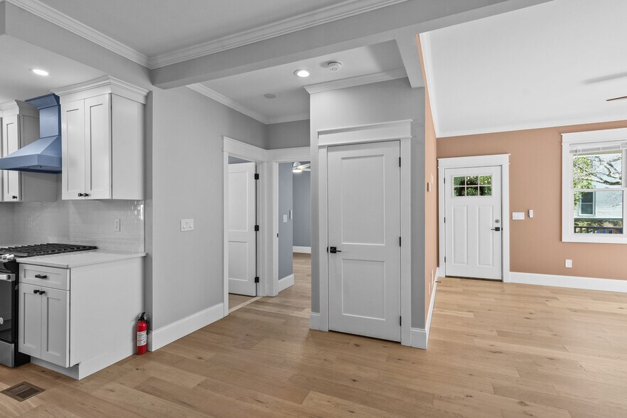 Another unfurnished angle of the front door and cross view of a part of the kitchen & down the hal - 20 Summer St