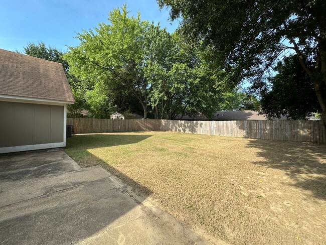 Building Photo - Charming 3BR/2BA Near Southwind | Soaring Vaulted Ceilings, Brick Fireplace & Fenced Yard