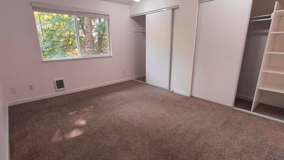 Spacious Primary Bedroom with abundant built-in storage. - 9494 Redmond Woodinville Rd NE