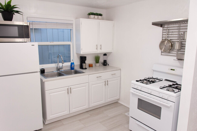 Kitchen with new floors and direct access to pantry/laundry room. - 100 Beaver St