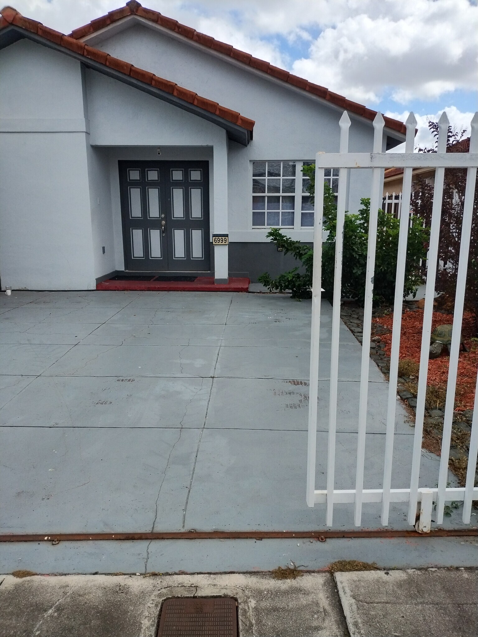 One parking space inside fenced driveway - 6999 W 25th Ave