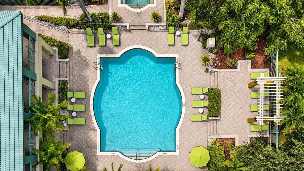 Relax in style at Club Mira Lago, where the stunning resort-style pool invites you to unwind. Surrounded by lush greenery and chic lounge seating, this oasis is perfect for sunny days and social gatherings. Reserve your spot in paradise today! - Club Mira Lago Apartments